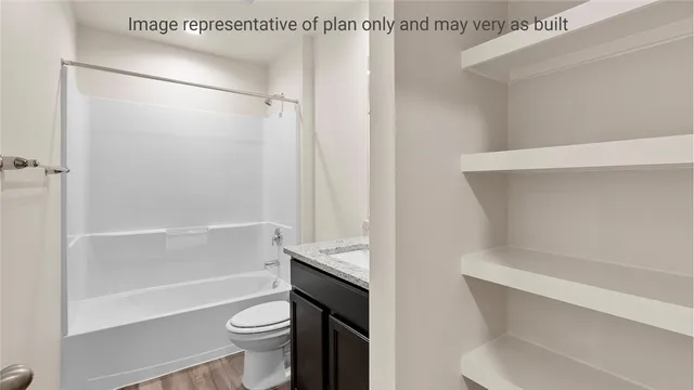 a bathroom with a granite countertop sink a toilet and a mirror