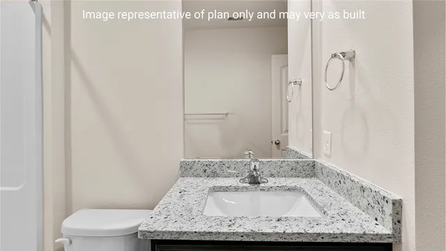 an empty room with a chandelier fan and closet