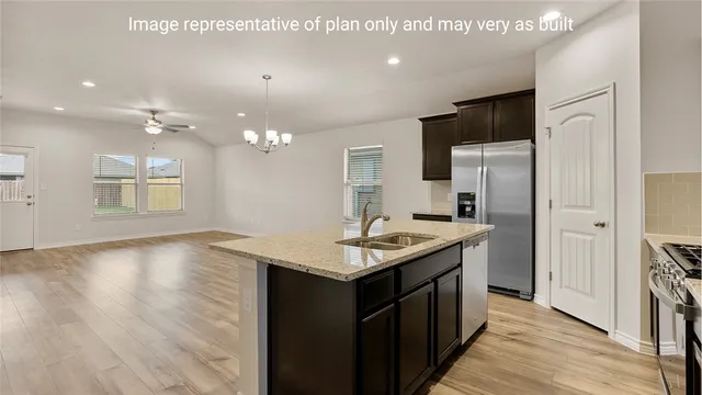 a kitchen with a sink and a refrigerator
