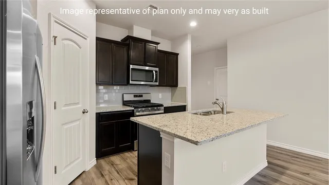 a kitchen with a stove a sink and a refrigerator