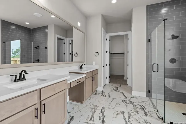 a bathroom with a shower sink double and mirror