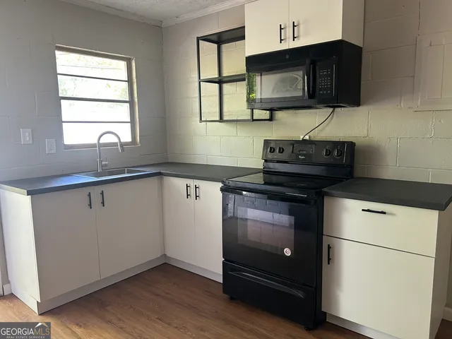 a kitchen with a stove and a microwave
