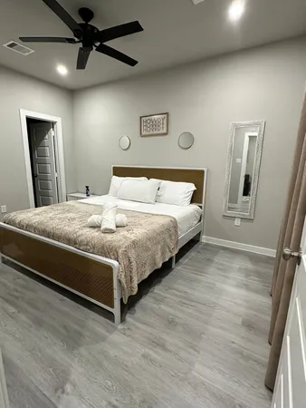 a bedroom with a large bed and a window