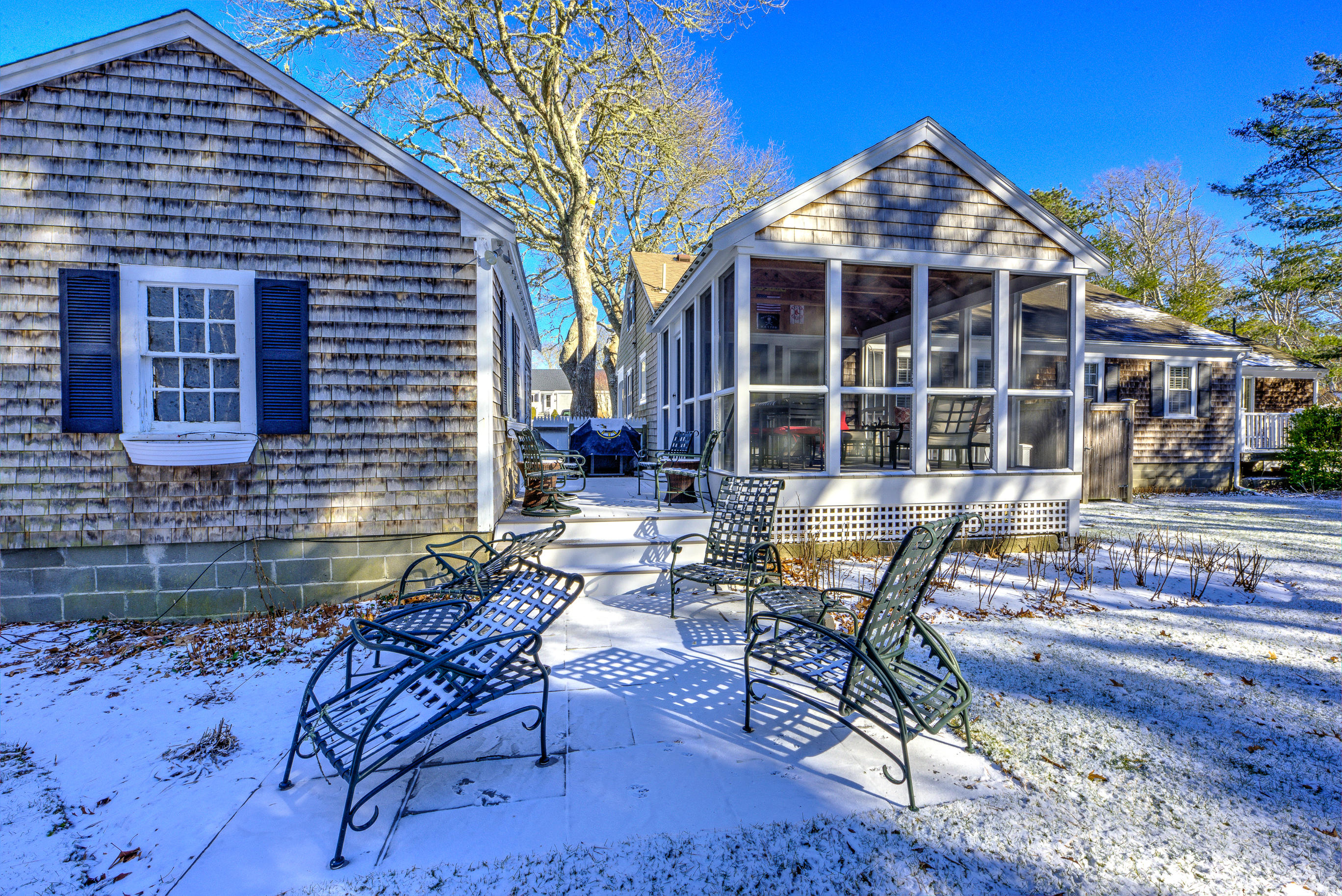 36 Deep Hole Road Harwich Port, MA 02646 - Photo 9 of 34 a view of a brick house with chairs and table in a patio
