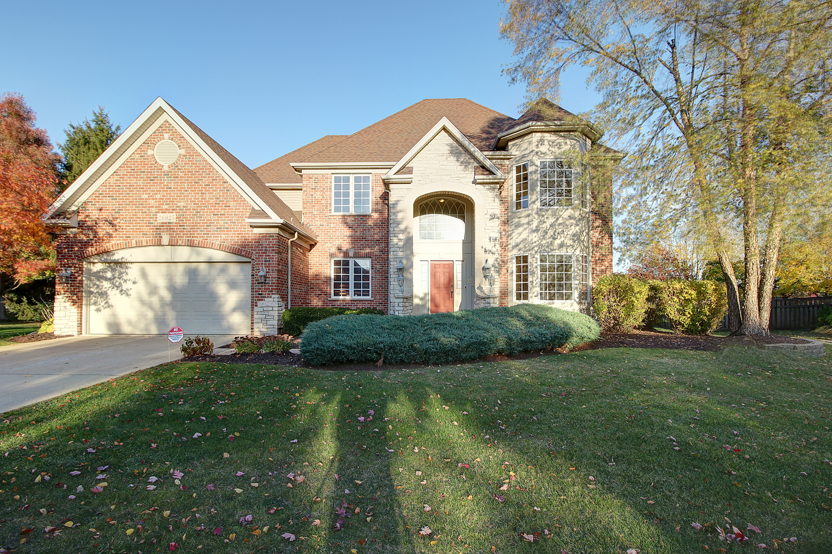 26025 Whispering Woods Circle Plainfield, IL 60585 - Photo 1 of 43 a view of a white house next to a yard with big trees