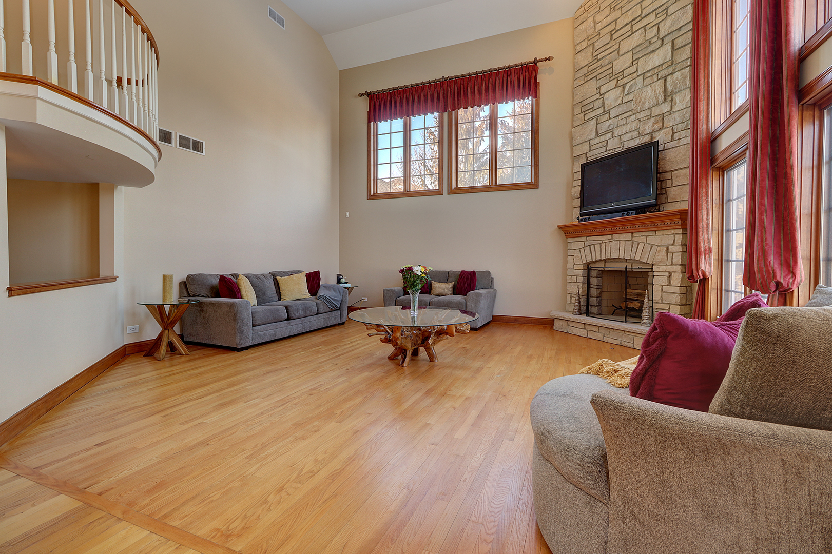 26025 Whispering Woods Circle Plainfield, IL 60585 - Photo 15 of 43 a living room with furniture a fireplace and a flat screen tv