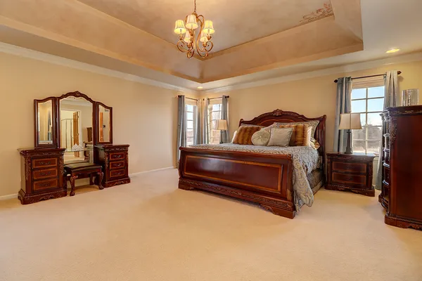 a bedroom with furniture and a chandelier