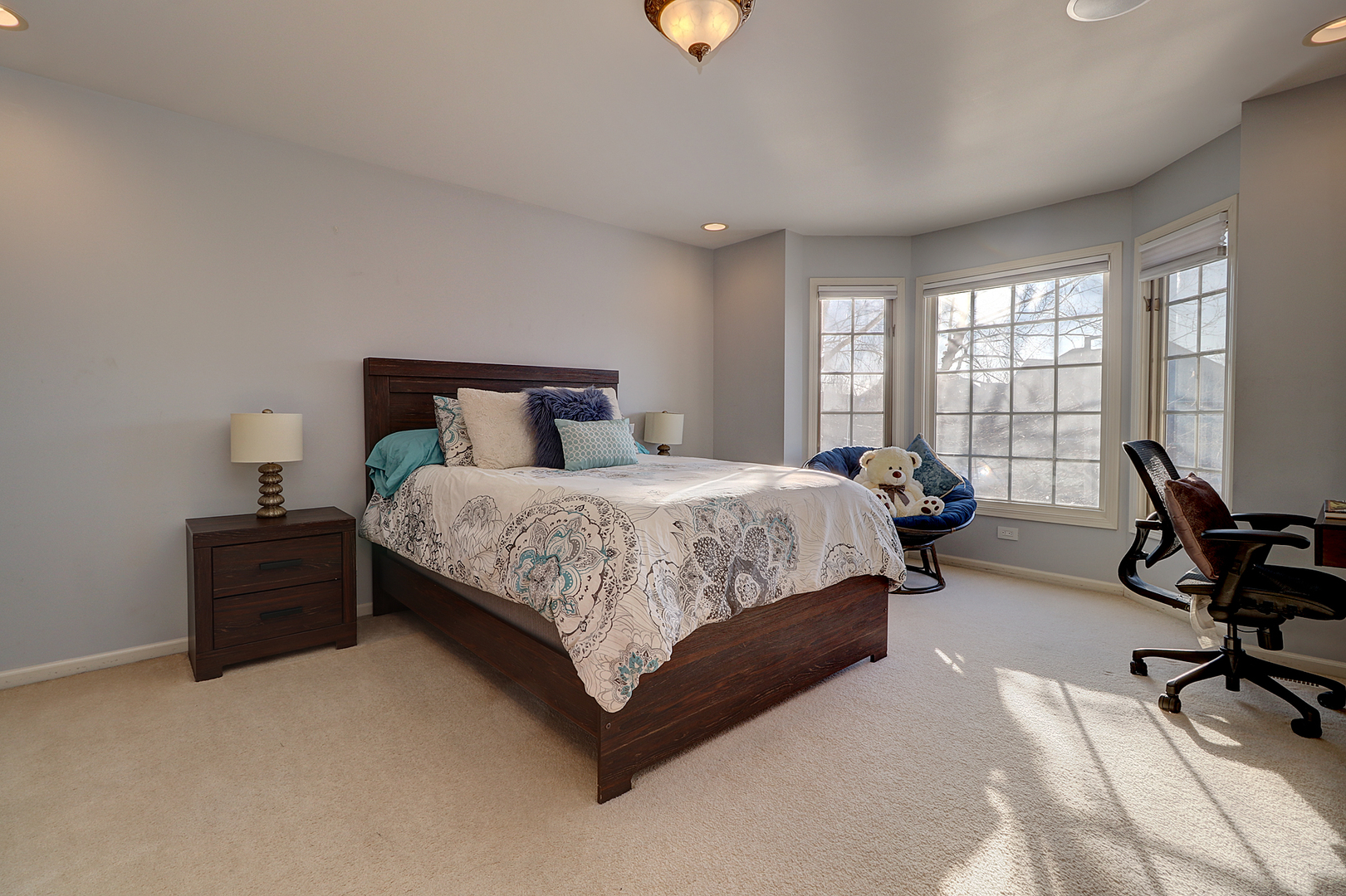 26025 Whispering Woods Circle Plainfield, IL 60585 - Photo 23 of 43 a bedroom with a bed a chair and a piano next to a large window