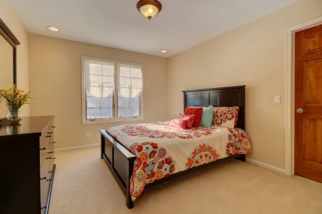 a bedroom with a bed lamp and a window