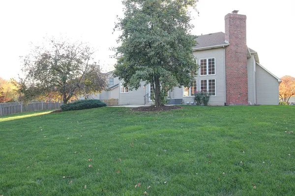 a view of a house with yard and a tree