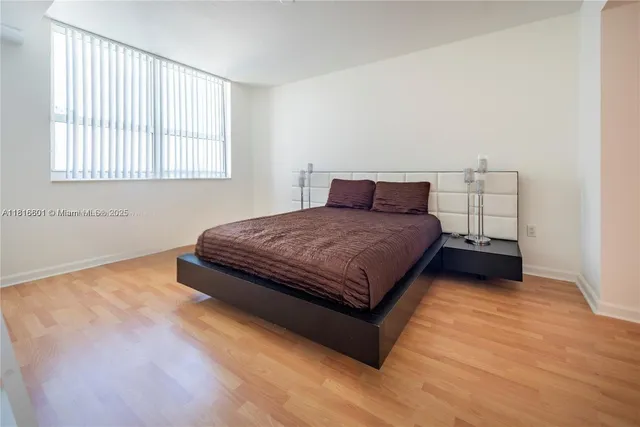 a bedroom with a bed and window