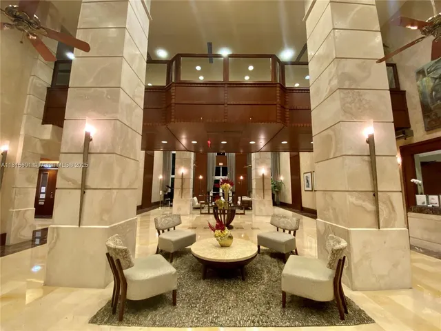 a view of a patio with couches and potted plants with sky view