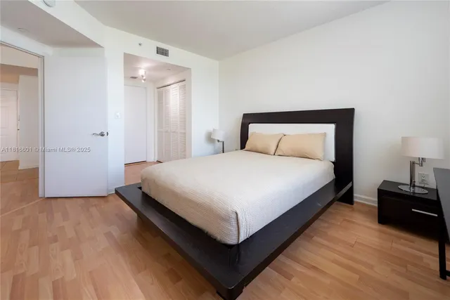 a bedroom with a bed and lamp