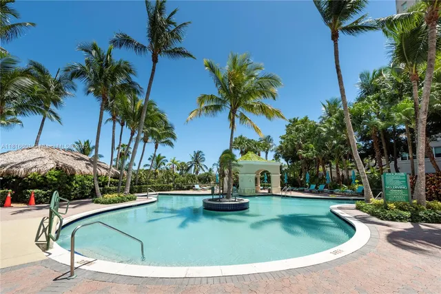 a swimming pool with barbeque oven outdoor seating and yard