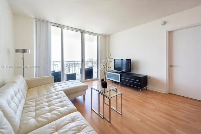 a bedroom with furniture and a flat screen tv