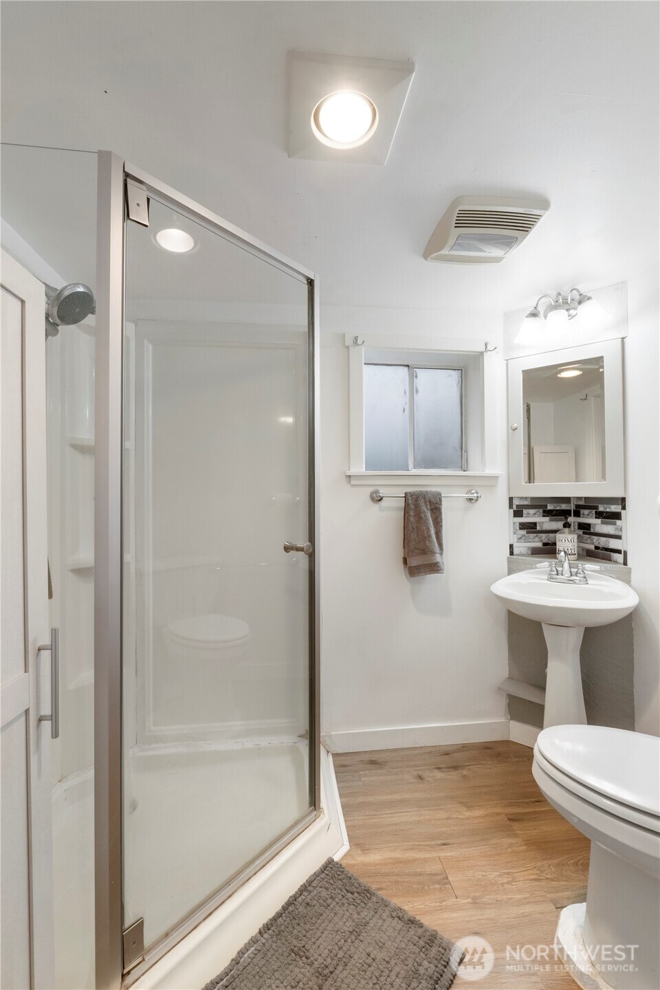 16419 92nd Street East Sumner, WA 98390 - Photo 21 of 39 a bathroom with a shower a toilet a sink and mirror