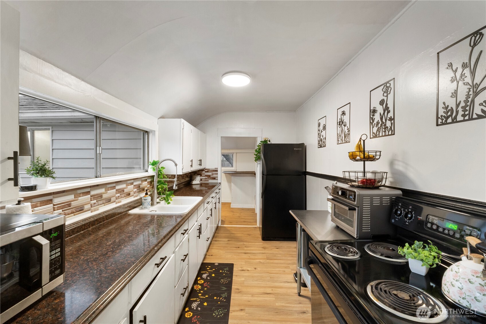 16419 92nd Street East Sumner, WA 98390 - Photo 10 of 39 a kitchen with stainless steel appliances granite countertop a sink stove and refrigerator