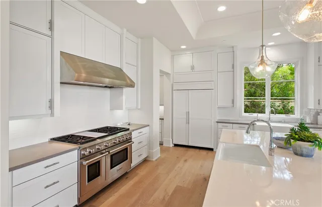 a living room with furniture large windows and a floor to ceiling window