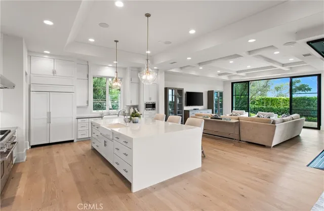 a large kitchen with a table and chairs