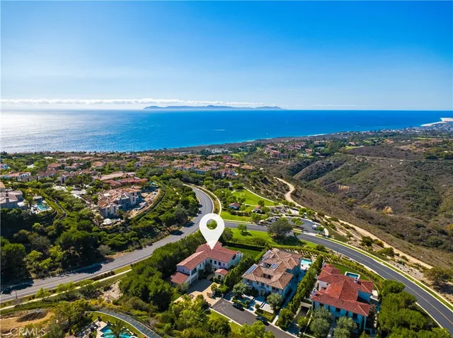 an aerial view of residential building and ocean