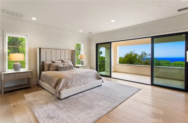 a bedroom with a bed and large window