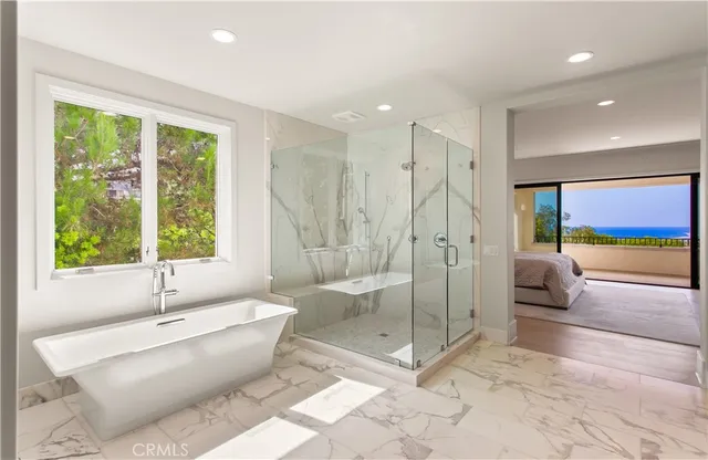 a view of a hallway with wooden floor and chandelier