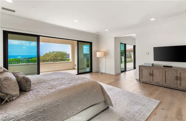 a bedroom with a balcony a bed and a window