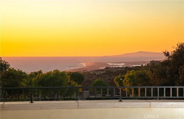 a view of a balcony with a floor to ceiling window and wooden fence
