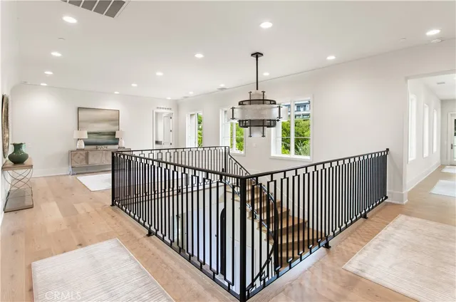 a bathroom with a toilet a sink a glass door a shower a mirror a vanity and window