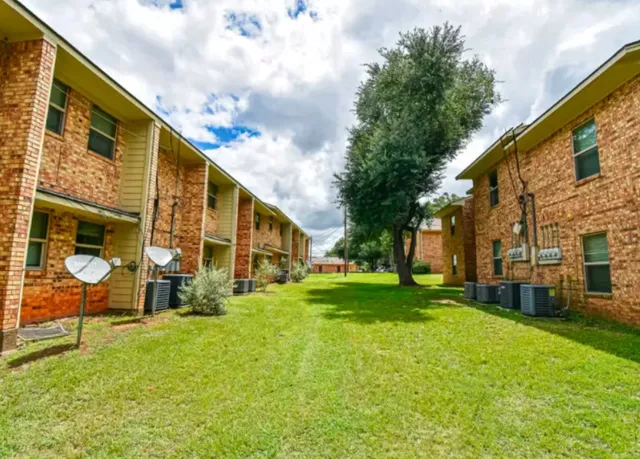 a view of a large trees next to a building