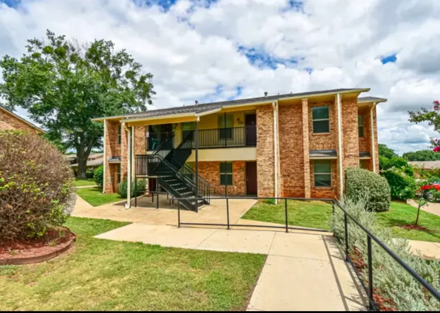 a view of a house with backyard porch and sitting area