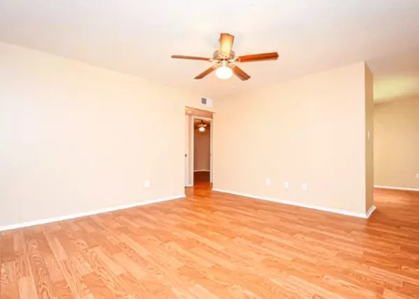 a view of a room with a ceiling fan and a window