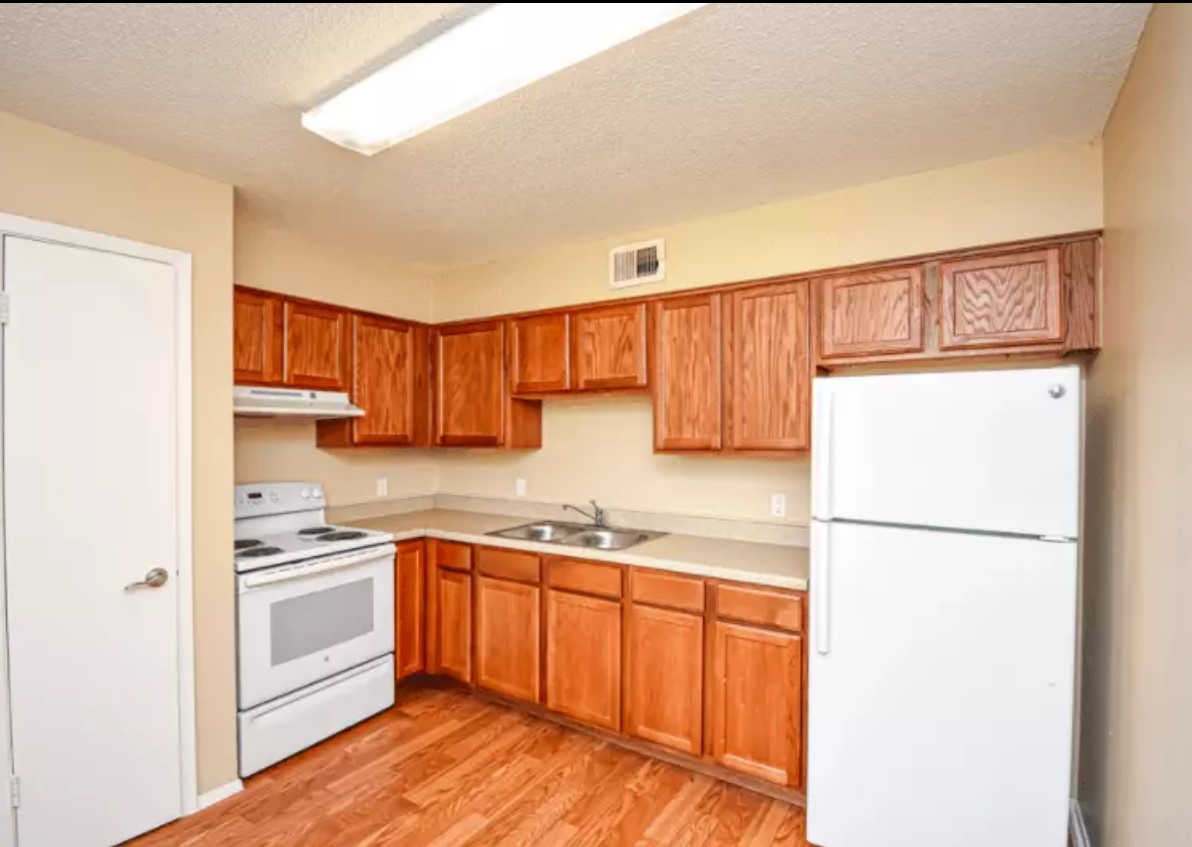 160 Gibson Road Athens, TX 75751 - Photo 9 of 11 a kitchen with a sink a refrigerator and a stove top oven