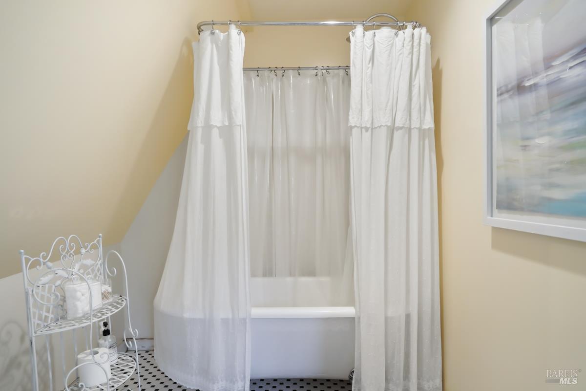 1846 Indian Valley Road, Unit A Novato, CA 94947 - Photo 39 of 45 a bathroom with a shower curtain and a sink