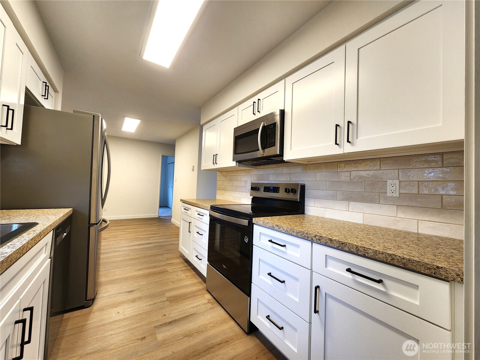 103 Kraft Road Longview, WA 98632 - Photo 9 of 19 a kitchen with stainless steel appliances granite countertop a stove a sink and a microwave