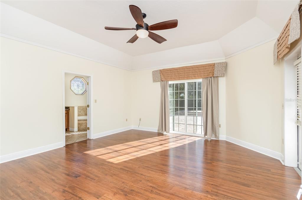 9217 Ridge Pine Trail Orlando, FL 32819 - Photo 17 of 37 a view of an empty room with wooden floor and a window