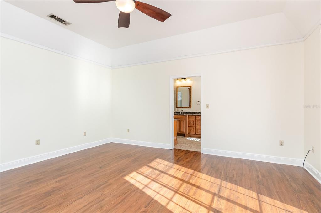 9217 Ridge Pine Trail Orlando, FL 32819 - Photo 18 of 39 an empty room with wooden floor closet and windows