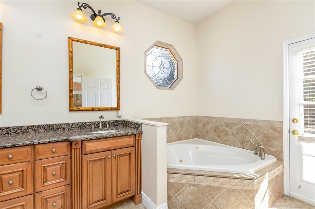 9217 Ridge Pine Trail Orlando, FL 32819 - Photo 21 of 37 a bathroom with a sink and a mirror