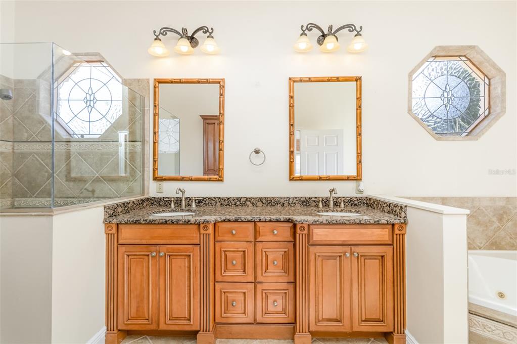 9217 Ridge Pine Trail Orlando, FL 32819 - Photo 22 of 37 a bathroom with a granite countertop sink and a mirror