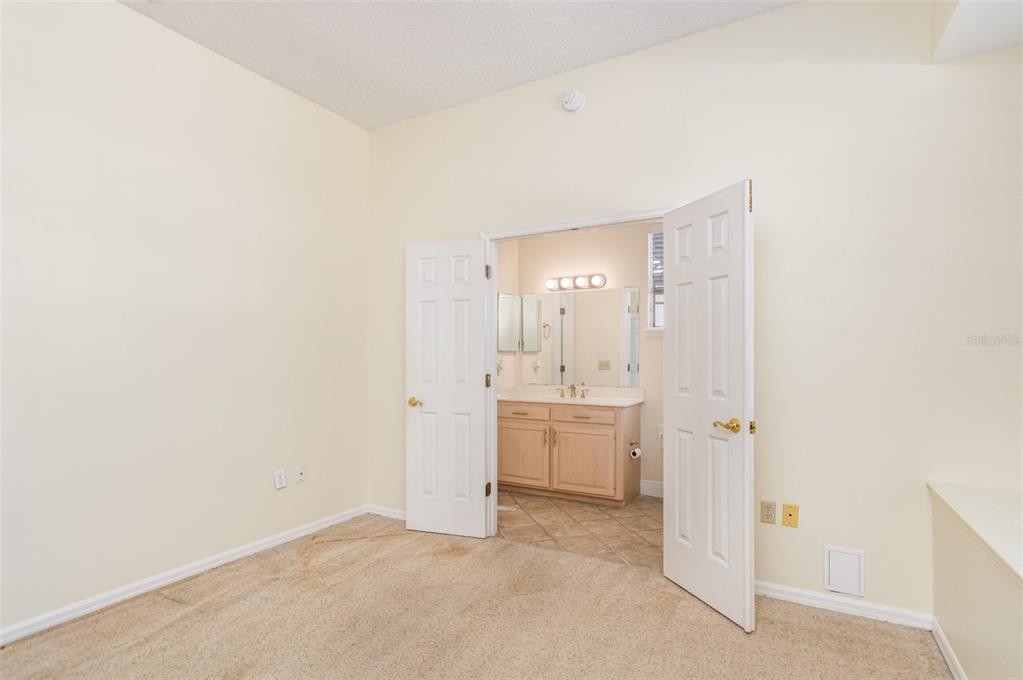 9217 Ridge Pine Trail Orlando, FL 32819 - Photo 29 of 37 a bathroom with a granite countertop sink and a mirror
