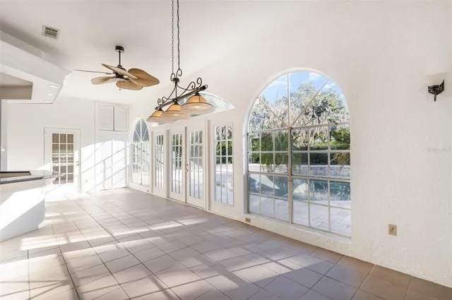 a view of a living room and chandelier fan