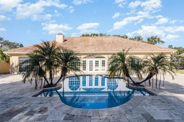 an outdoor space with swimming pool and furniture