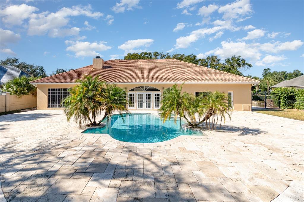 9217 Ridge Pine Trail Orlando, FL 32819 - Photo 33 of 39 a view of a house with a backyard