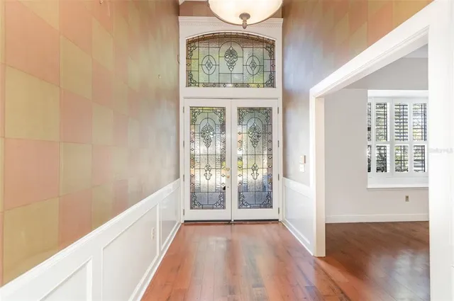 a view of an entryway with wooden floor and a window