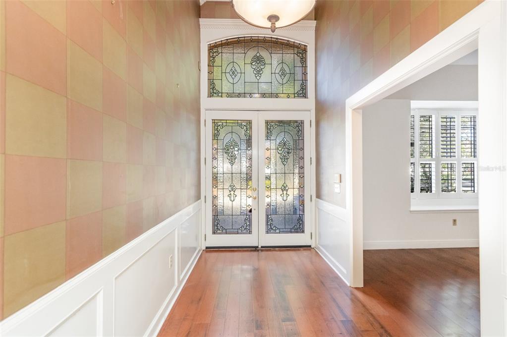 9217 Ridge Pine Trail Orlando, FL 32819 - Photo 4 of 39 a view of an entryway with wooden floor and a window