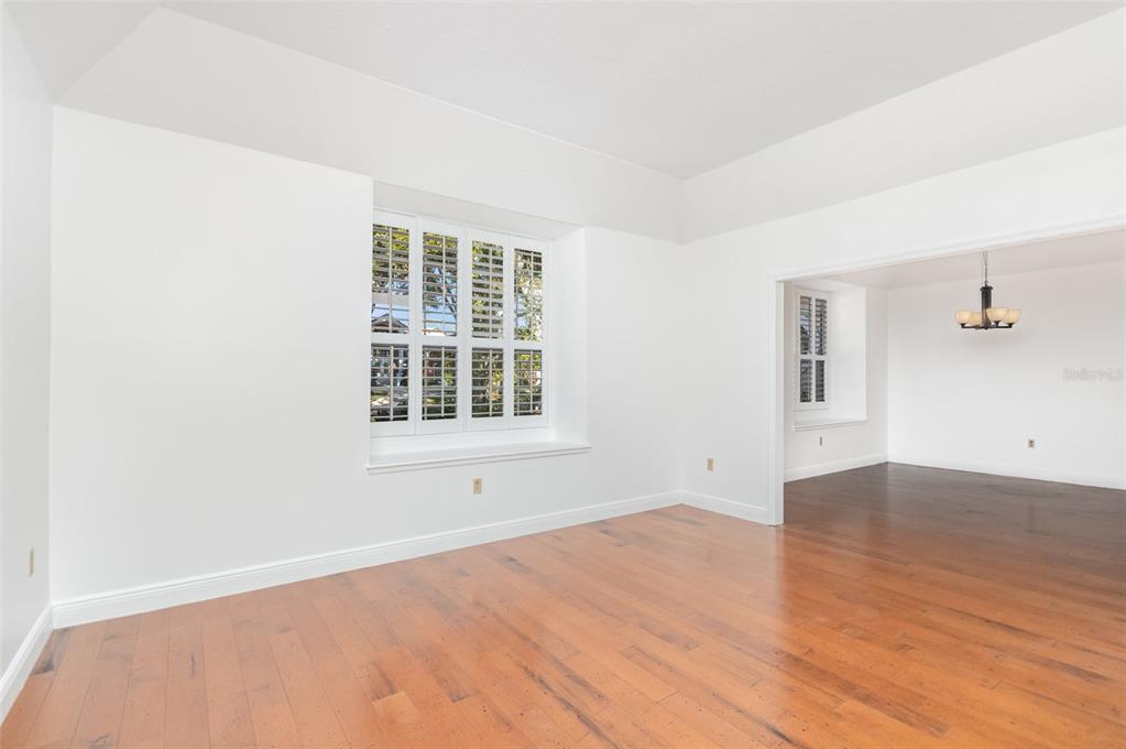 9217 Ridge Pine Trail Orlando, FL 32819 - Photo 9 of 39 an empty room with wooden floor and windows