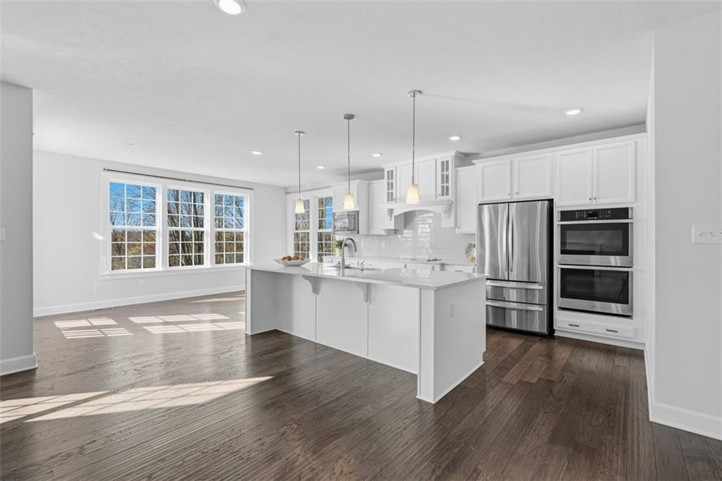 641 Tullamore Trail Mars, PA 16046 - Photo 17 of 47 a large white kitchen with kitchen island wooden floors and stainless steel appliances