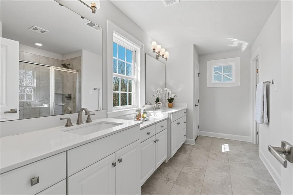 641 Tullamore Trail Mars, PA 16046 - Photo 27 of 47 a bathroom with a double vanity sink a toilet and a shower