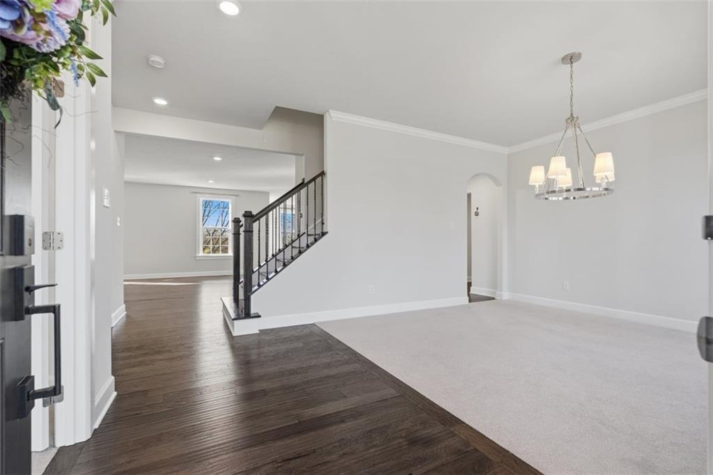 641 Tullamore Trail Mars, PA 16046 - Photo 4 of 47 a view of an empty room with wooden floor staircase and a chandelier