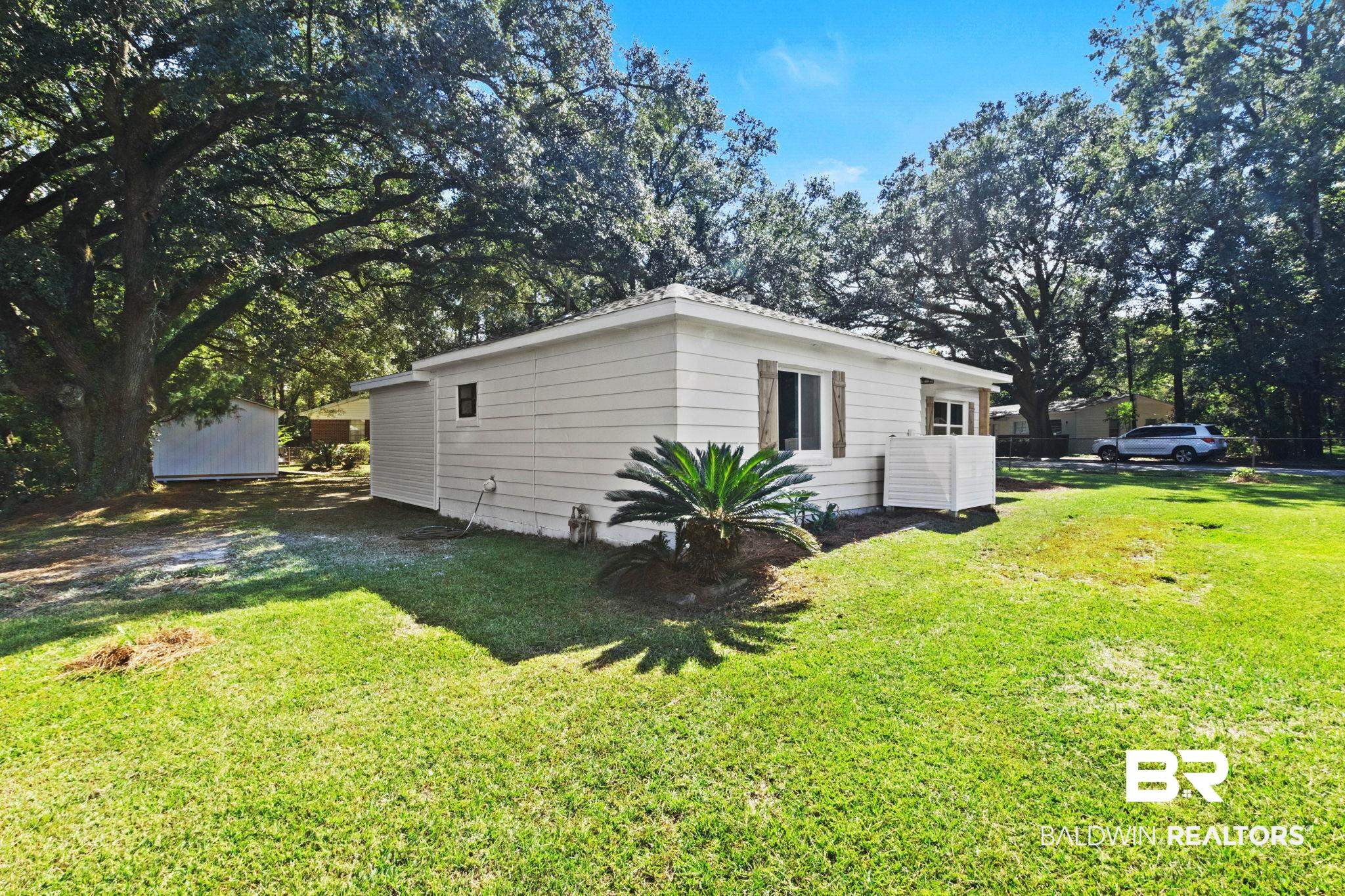 618 Pine Street Saraland, AL 36571 - Photo 27 of 41 View of side of property featuring a yard